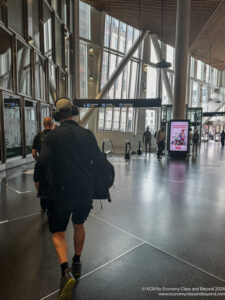 a man wearing headphones walking in a large building