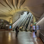 a group of people walking in a subway station