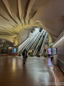 a group of people walking in a subway station