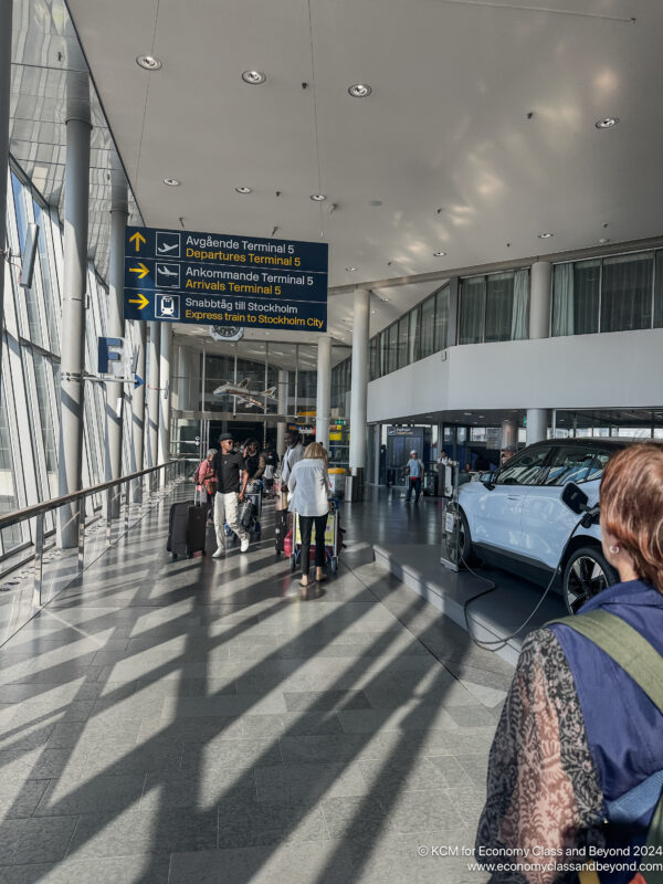 people in a building with cars and people