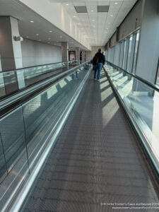 a people walking on a moving walkway