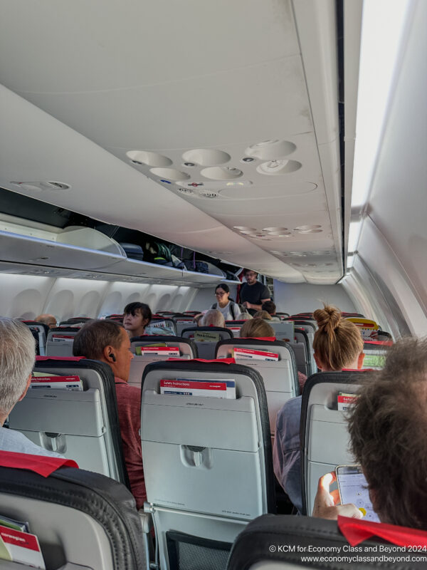 a group of people sitting in an airplane