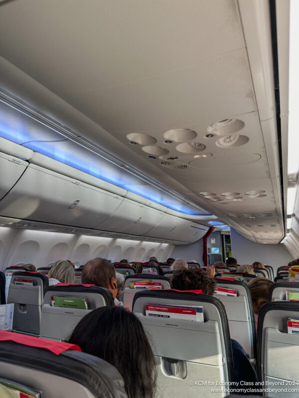 a group of people sitting in an airplane