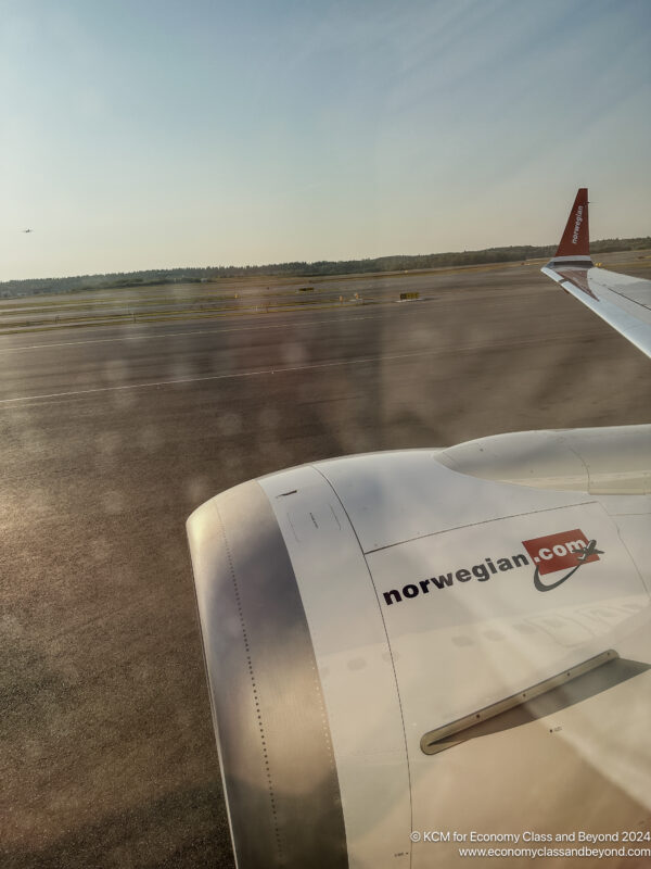 the wing of an airplane on a runway