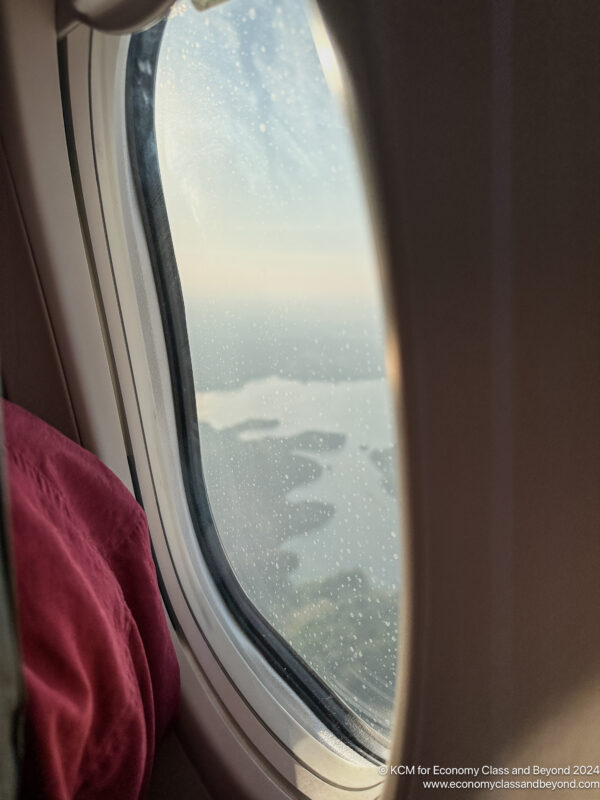 a window with a view of the ocean and land