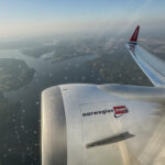 an airplane wing and body of water