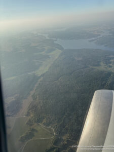 an aerial view of a river and land