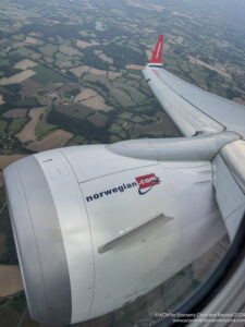 an airplane wing with a red and white logo