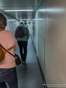 a man and woman walking down a hallway