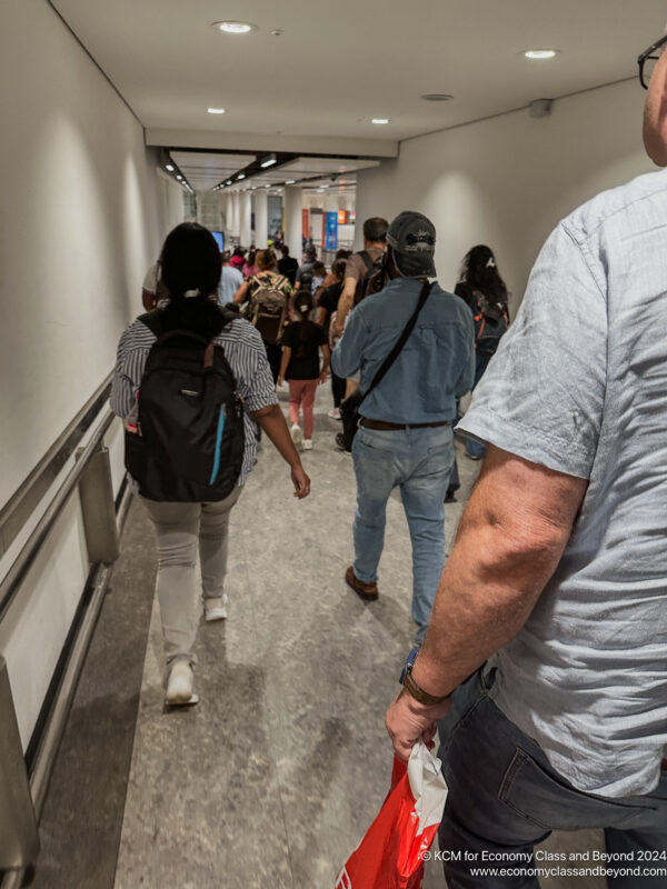 a group of people walking in a hallway