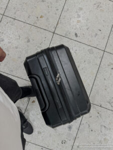 a black suitcase on a tile floor