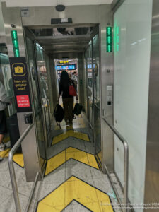 a woman walking through an elevator