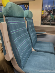 a blue and white seats on a train