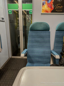 a blue chairs in a train