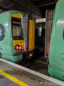 a green train with yellow and black stripes