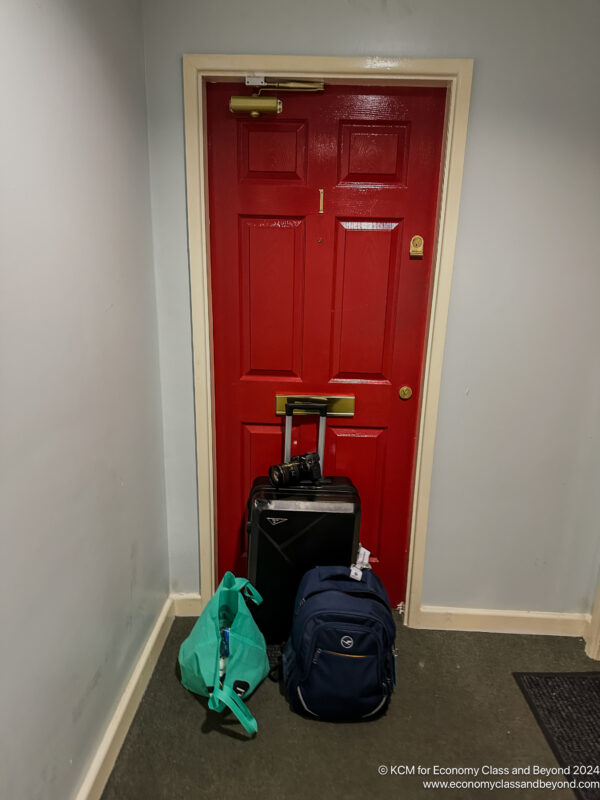 a red door with luggage on it