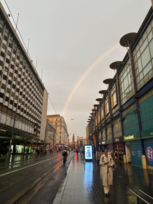 a rainbow over a city street