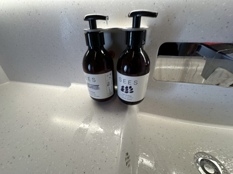 a two bottles of liquid on a sink