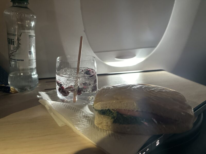 a sandwich and a glass of water on a table