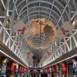 a large globe with pink ribbons from the ceiling