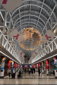 a large globe with pink ribbons from the ceiling