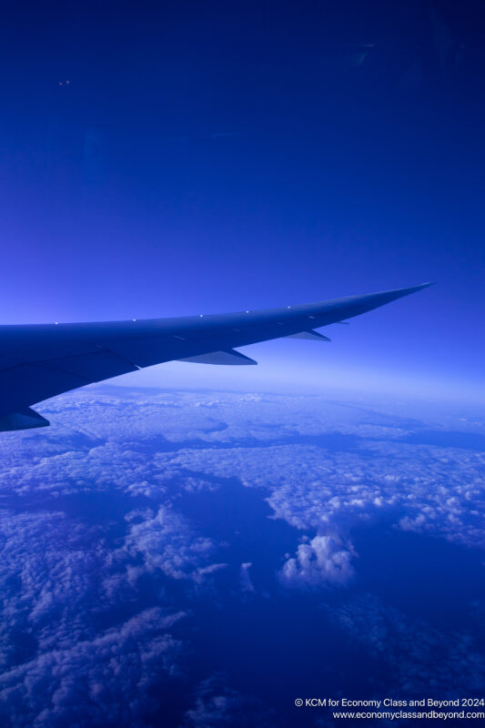 an airplane wing in the sky