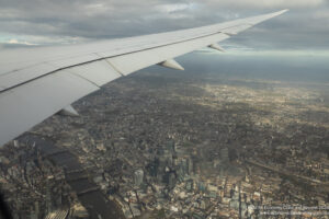 an airplane wing over a city