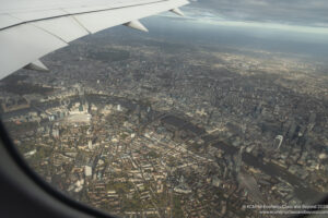 an airplane wing and a city