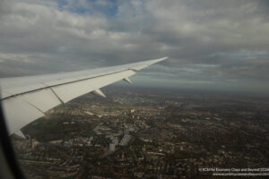 an airplane wing and city below