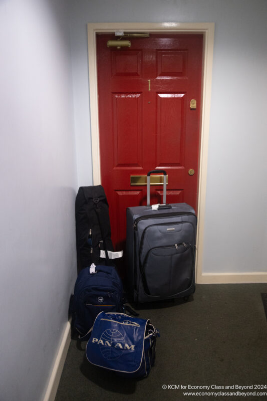 a red door with luggage on it