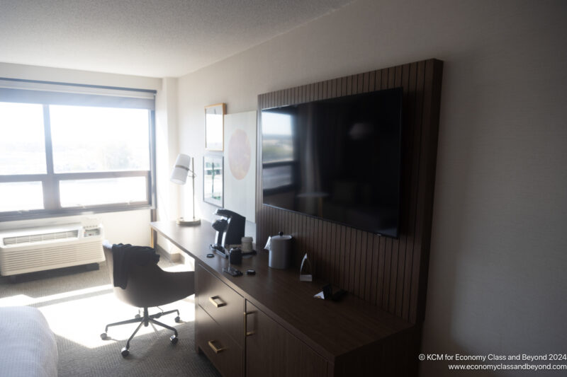 a desk with a television and a chair