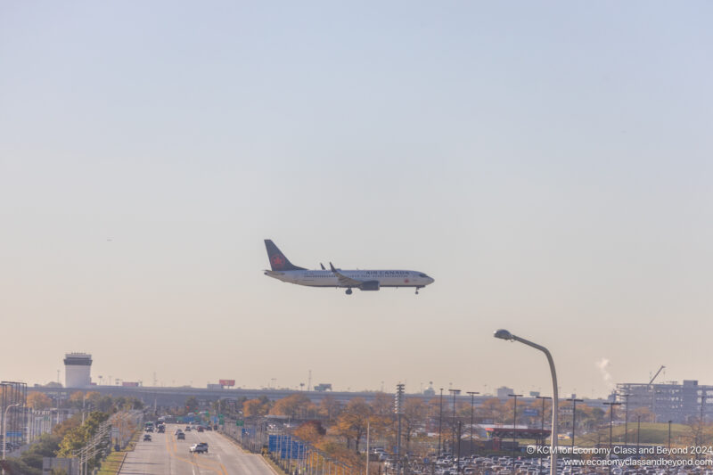 an airplane flying over a road