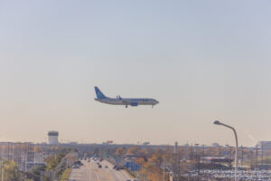 an airplane flying over a road