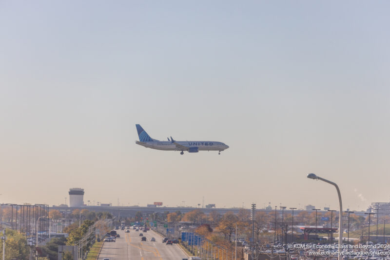 an airplane flying over a road