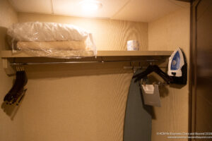 a ironing board and iron on a shelf