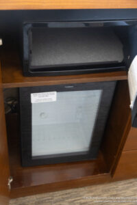 a black rectangular object on a wooden shelf