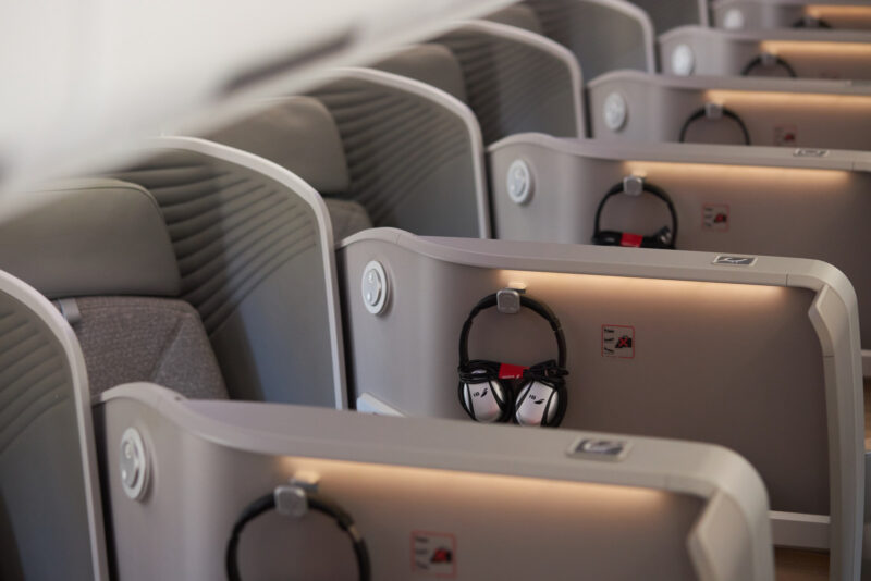 a row of seats with headphones on