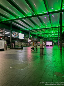 people in a train station with green lights