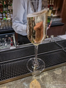 a glass of champagne on a bar