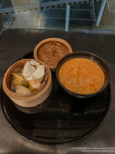 a group of bowls of food on a black plate