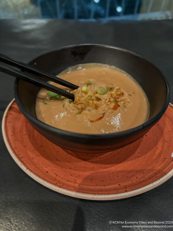 a bowl of food with chopsticks