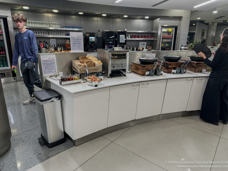 a man standing next to a counter with food on it