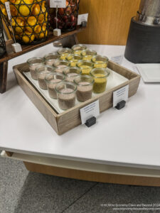 a tray of small jars with different colored grains