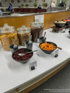 a table with bowls of food and cereals