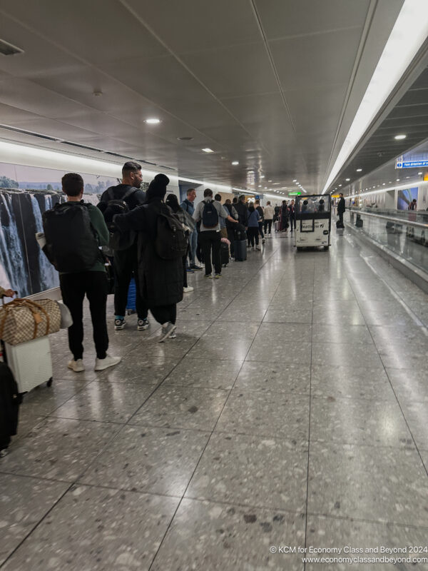 a group of people standing in a hallway