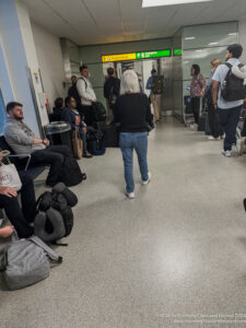 a group of people waiting in a hallway