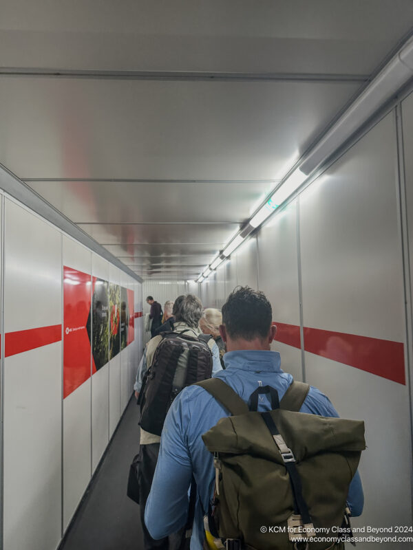 a group of people walking down a hallway