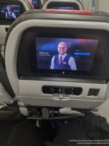 a tv screen on the back of an airplane