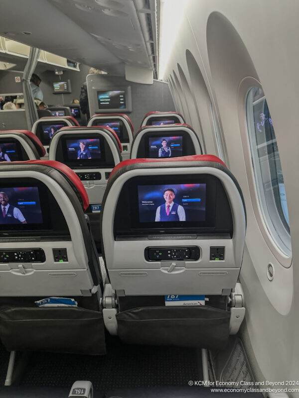 a row of seats with tvs on the back