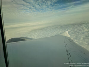 an airplane wing above the clouds